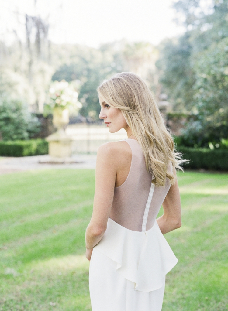 SERENE REALM: Amsale’s “Demi” fit-to-flare silk crepe gown with illusion back and peplum from White on Daniel Island.