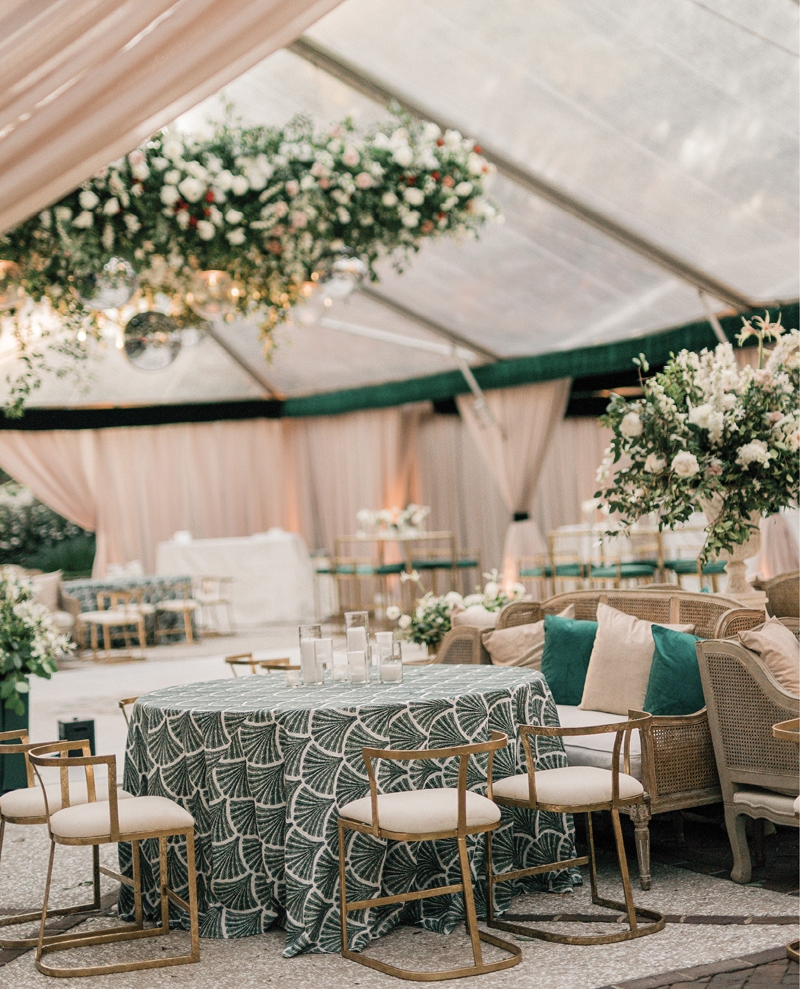 An abundance of cozy nooks allowed for ample seating during the reception. “I knew I wanted a Christmas vibe, but I didn’t want everyone to feel like they had just walked into the North Pole—I was thinking more of a fun holiday party with bright lights and glitz,” Morgan says. Varying shades of green were spiced up with twinkle lights and touches of gold.