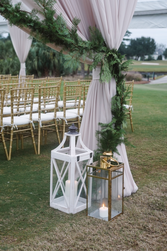 Designer Ellen Robinson opted to forego red and accent the party with soft whites and metallic gold touches, all set aglow with lanterns and candlelight.