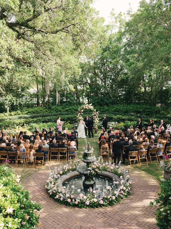 Coastal blues and greens with pops of pink and white were the colors of the day. Lori DeNicola of Petaloso made statement floral displays with the fountain and ceremony arch.