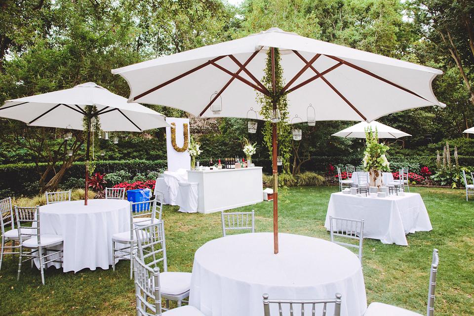 SITTING PRETTY: Loluma set the outdoor tables with white linens and Chiavari chairs—a clean and crisp that balanced well with the colorful flowers and natural elements.