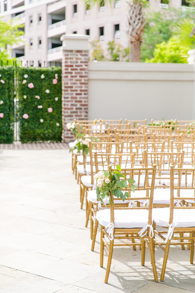 TIP: Opt for classic chiavari chairs. The gilded version of the bamboo chairs never go out of style. Pair them with snow-white cushions and table linens to temper the elegance for a summery vibe.  Image by Dana Cubbage Weddings