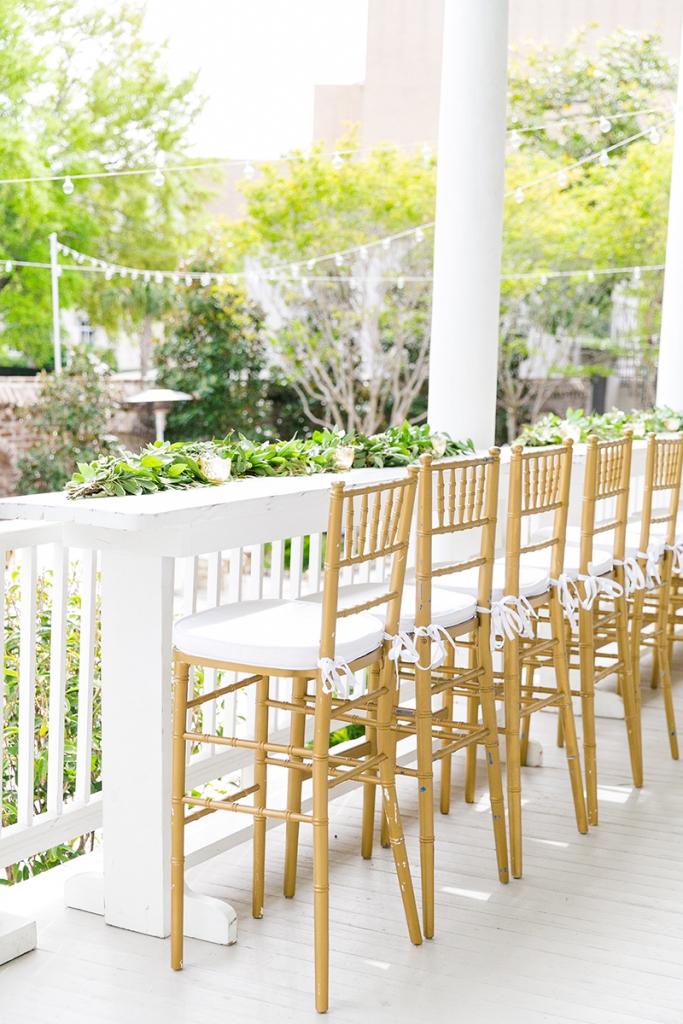 TIP: Opt for classic chiavari chairs. The gilded version of the bamboo chairs never go out of style. Pair them with snow-white cushions and table linens to temper the elegance for a summery vibe.  Image by Dana Cubbage Weddings