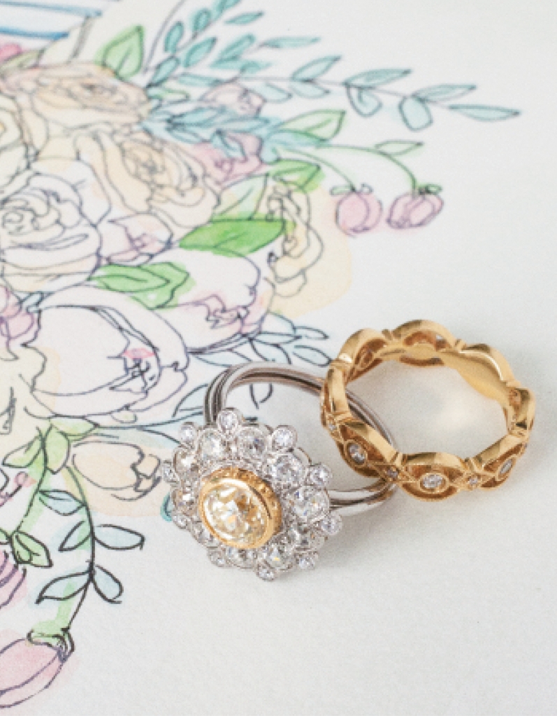 (from left) Platinum and yellow gold ring with 1.46 ct. diamond center and accent diamonds (2.86 total cts.) from Joint Venture Estate Jewelers, $12,500. Gabriel &amp; Co.’s 14K yellow gold band with diamonds (.3 total cts.) from Polly’s Fine Jewelry, $1,950. Artwork by Natalie Taylor Humphrey
