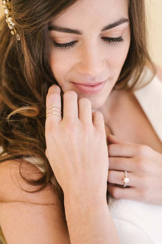 Emma Katzka’s “Rachel” comb with pearls and crystals from Lovely Bride. David Yurman’s chevron ring with diamonds (.3 total cts.) from REEDS Jewelers. Jack Kelége’s white and rose gold diamond (.68 total cts.) ring from Diamonds Direct. Charles Garnier “Daniela” gold and sterling mesh cuff with cubic zirconias from Croghan’s Jewel Box. Matthew Christopher’s “Eden” gown from Southern Protocol Bridal.