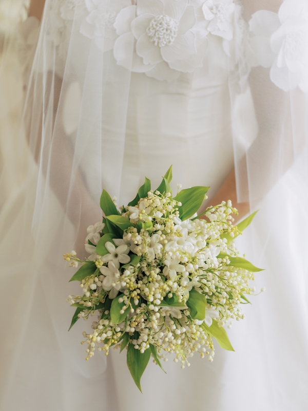 The bride’s understated bouquet of jasmine and lily of the valley.