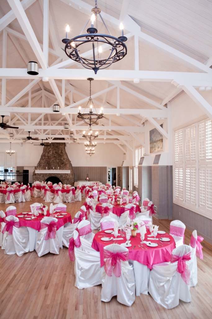 DINE AND SHINE: Fuchsia table accents popped against the neutral hues of the Sand Dunes Club reception hall. Rentals were provided by Snyder Event Rentals
