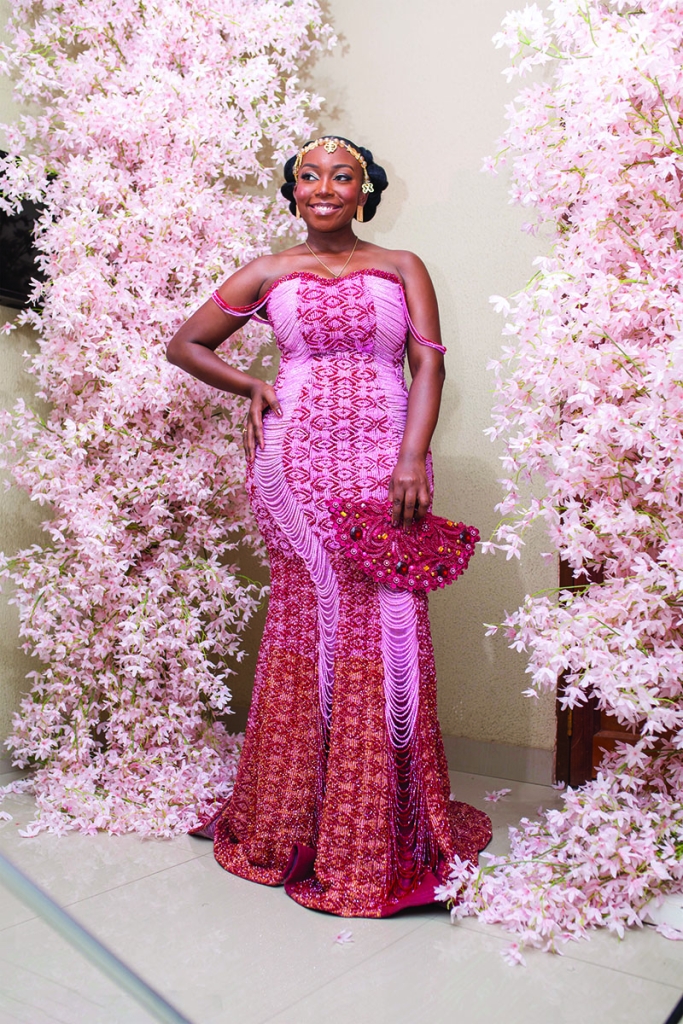 For their December wedding, Micheala donned a hand-beaded corset gown by Ghanaian designer Eunice Abena Pomaa, while Ebenezer made a regal statement in a coordinating kente cloth.