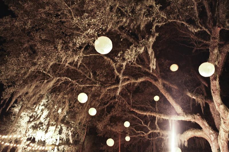 TRIM THE TREE: Oak trees were illuminated by 20 paper lanterns, hung and lit by the bride and groom themselves.