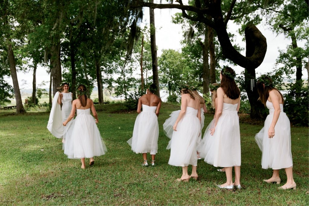 Bridesmaids wore tea-length white tulle dresses from Alexandra Grecco. “With their flower crowns, they looked like little nymphs!” says the bride.  &lt;i&gt;Photograph by Olivia Rae James&lt;/i&gt;