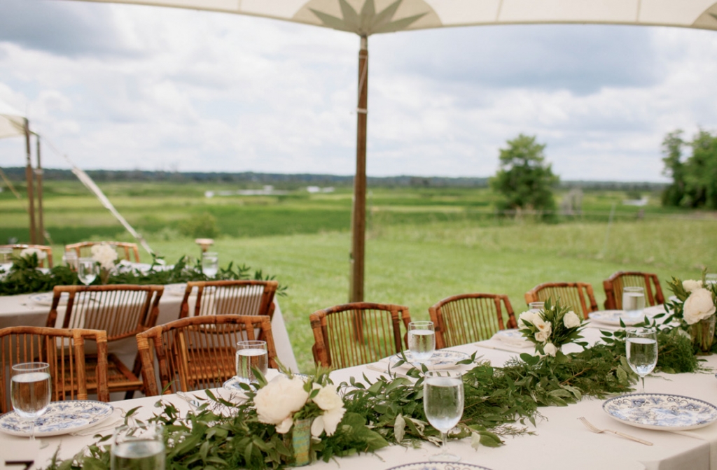 The bride limited the table design to simple garlands and chargers so as not to compete with the natural beauty of the Combahee River.  &lt;i&gt;Photograph by Olivia Rae James&lt;/i&gt;