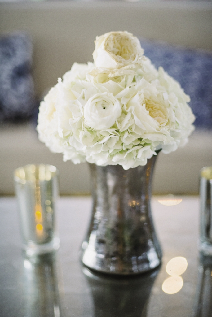 TOUCH OF GLAM:  Mercury glass vases  and tea light votives added luxe shimmer to tablescapes without overpowering the  elegant simplicity.
