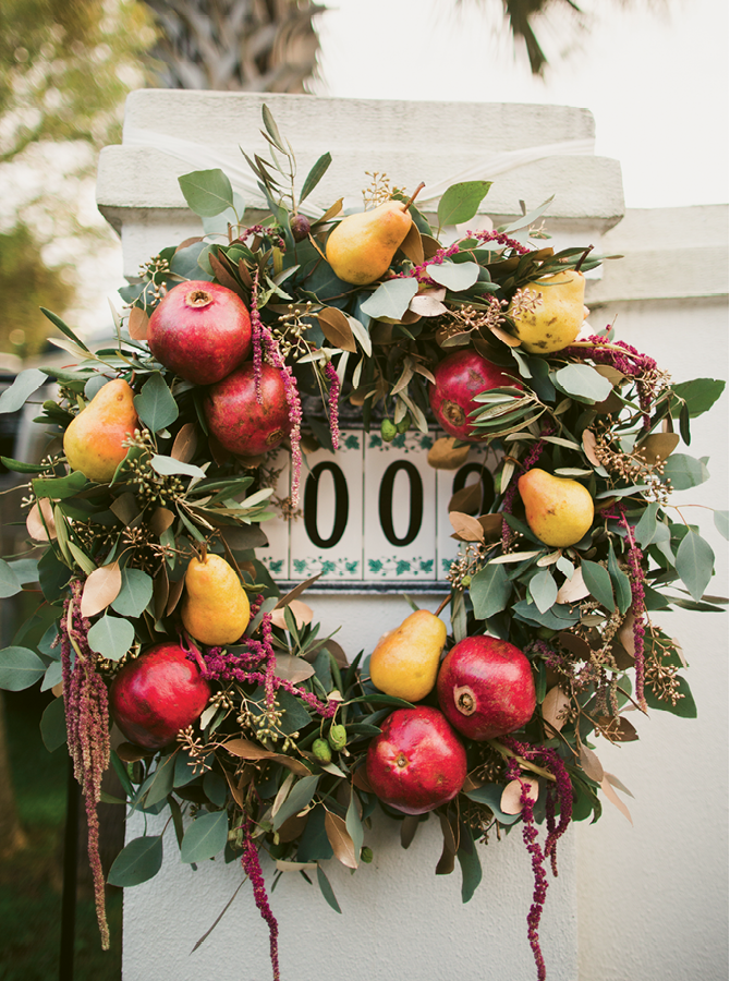 Branch Design Studio integrated pomegranates and pears into harvest-style wreaths.  (Image by Juliet Elizabeth Photography)