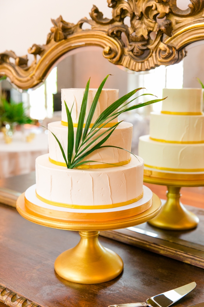 “Mike couldn’t make it to our tasting, so DeClare sent us sample cakes for my birthday,” recalls Kate. Golden bands circling each tier and a single palm frond completed the dessert’s modern design. &lt;i&gt;Photograph by Dana Cubbage Weddings&lt;/i&gt;