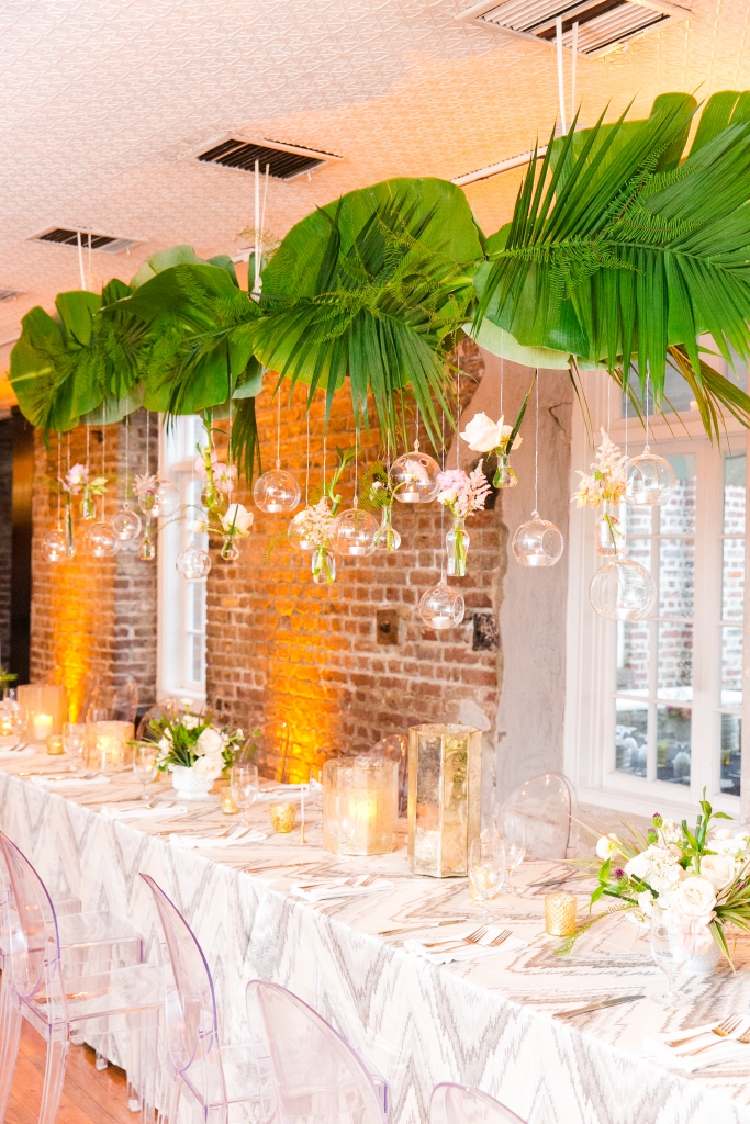 Greenery is often more cost-effective than florals, so the overhead installation of palm fronds, banana leaves, and sea star fern was as budget-savvy as it was stunning. &lt;i&gt;Photograph by Dana Cubbage Weddings&lt;/i&gt;