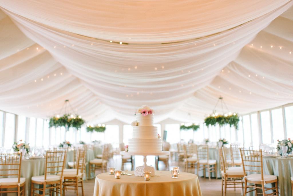 Photograph by Sean Money + Elizabeth Fay. Design, draping, and florals by A Charleston Bride. Rentals by Snyder Event Rentals. Cake by Ashley Bakery.