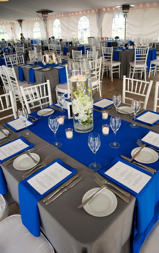 WELL PLACED: Cobalt and pewter-colored linens from EventWorks dressed the square reception tables. For centerpieces, Judy Johnston of Engaging Events submerged orchids in tall glass vases.