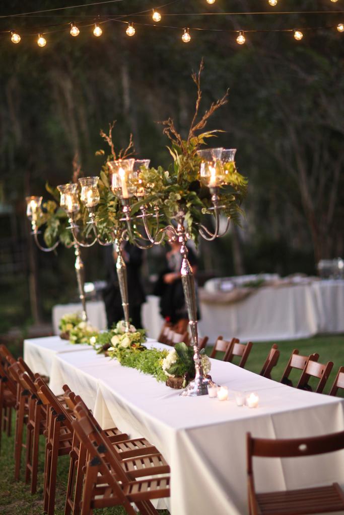 A FINE FIT: Grand candelabras holding fern centerpieces were well-suited for the open air space.
