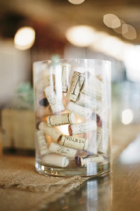 TOASTY TIMES: The couple gathered more than 4,000 corks from area restaurants for wedding crafts. To make this lantern, place a tall votive holder in a vase, then fill the space between the two with corks before slipping a tealight into the inner vase.