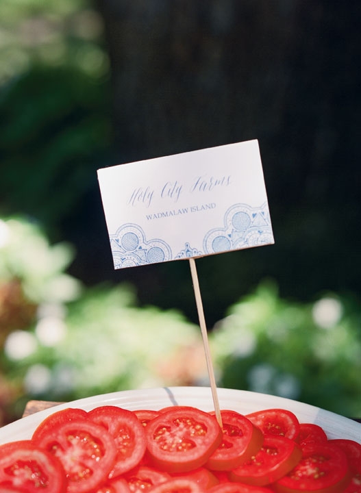 To celebrate summer flavors during the post-ceremony cocktail hour, Cru Catering set up an heirloom tomato tasting bar outside with house-smoked mozzarella and fresh basil. Tags (with my niece&#039;s invitation motif) noted the varieties and farms.