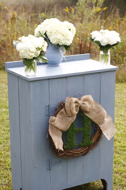 The ceremony &quot;altar&quot; was dressed in family ceramics filled with fresh blooms.