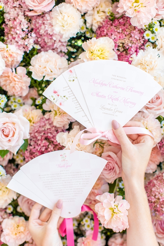 Studio R created custom ceremony programs shaped as fans—a cool touch in the June heat.