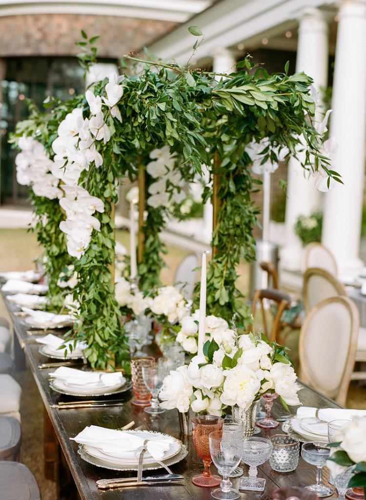 Table Talk - Cover trellis-style  frames in greenery and blooms to wrap dining tables in flora without cluttering place settings or obstructing eye contact.