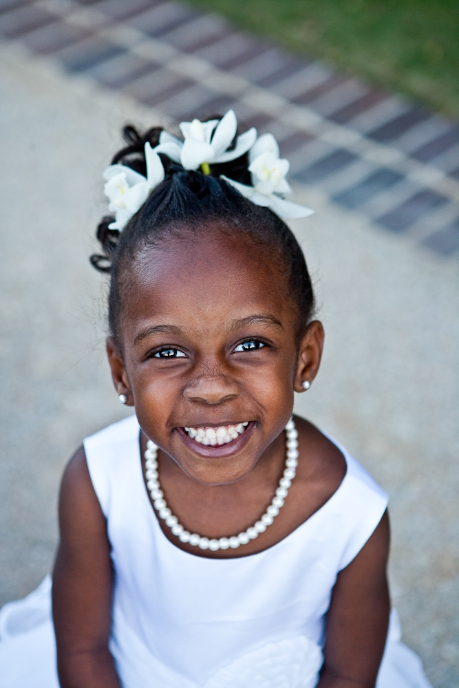 PEARLY WHITES: Flower girl Jayda, the bride’s goddaughter, was all smiles in her ivory outfit complete with pearls.
