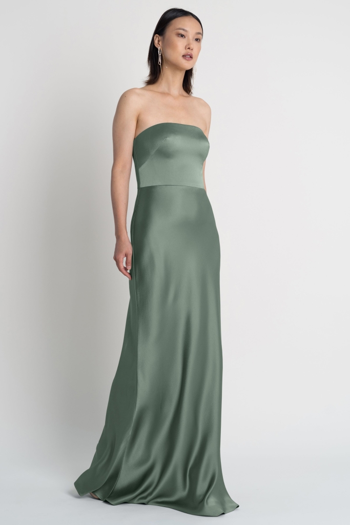 Sleek Satin - Jenny Yoo “Melody” strapless gown with bias-cut skirt in “eucalyptus,” $290 at Bella Bridesmaids