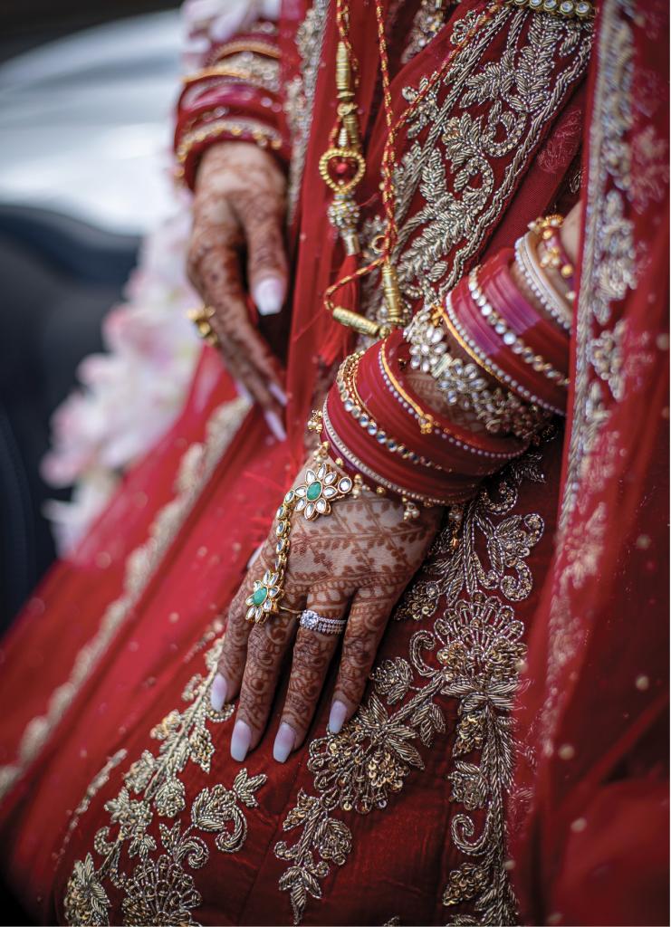 One of several immaculate custom gowns worn throughout the weekend, Swati’s traditional red bridal attire (called a lehenga) was complemented with ornate jewelry and intricate henna art on her hands and feet.