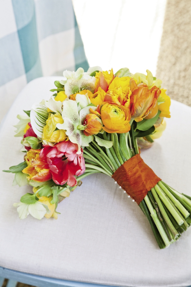 BRIGHT IDEA: coral begonia, bird’s nest fern, green hellebores, variegated ivy, chartreuse phalaenopsis orchids, orange and gold ranunculus, rosemary, and tulips made up the bouquet.