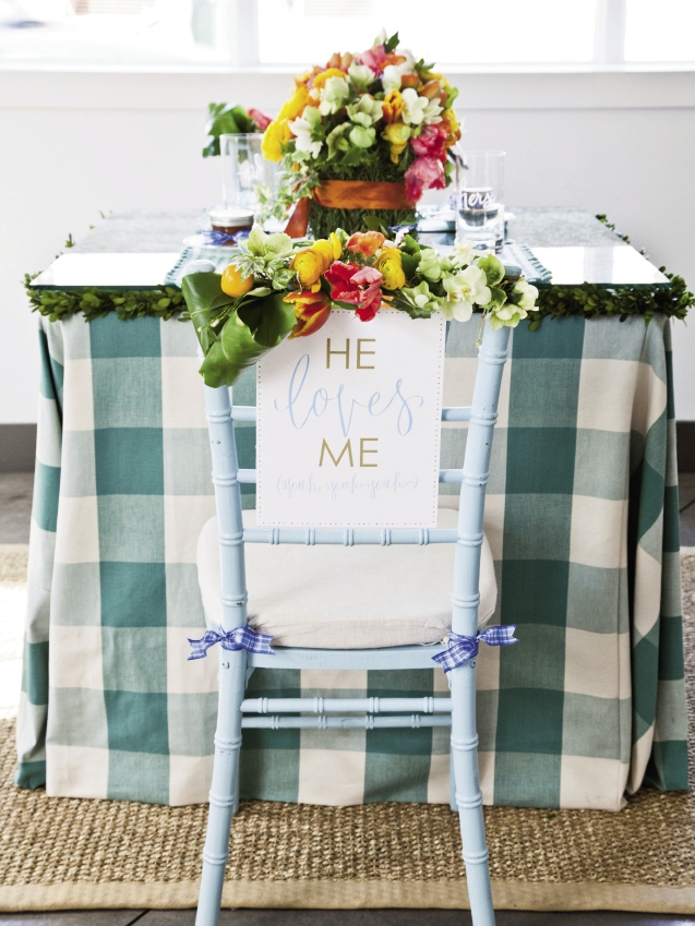 SIGN OFF: “He/She Loves Me, yeah, yeah, yeah” signs by Hardink Calligraphy and dodeline designs hung on the couple&#039;s chairs.