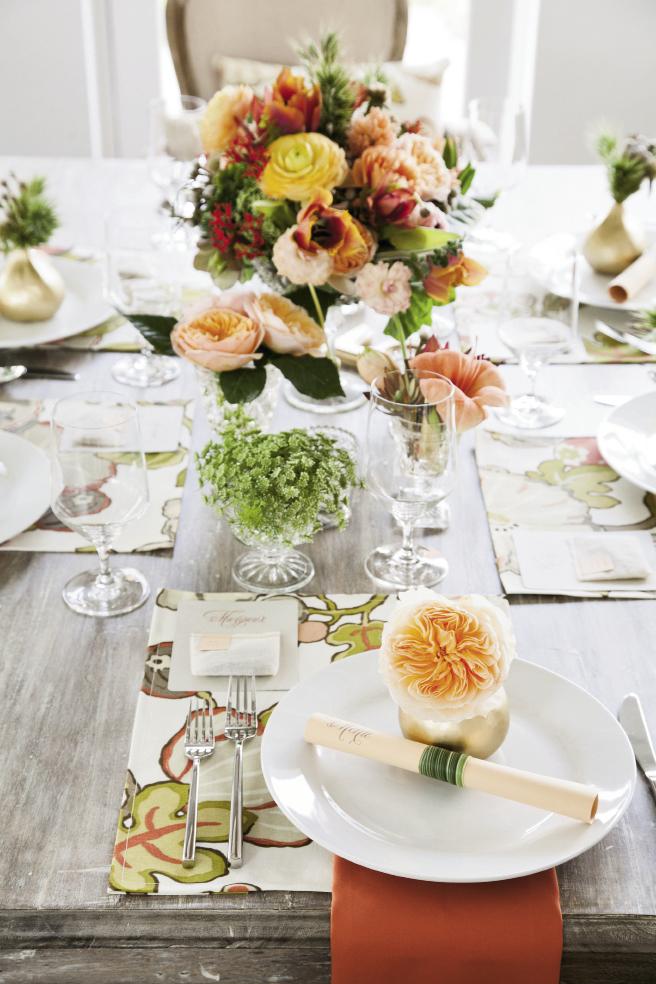 GARDEN PARTY: Flanking the dominant arrangement and topping place settings with bud vases added pops of color throughout.