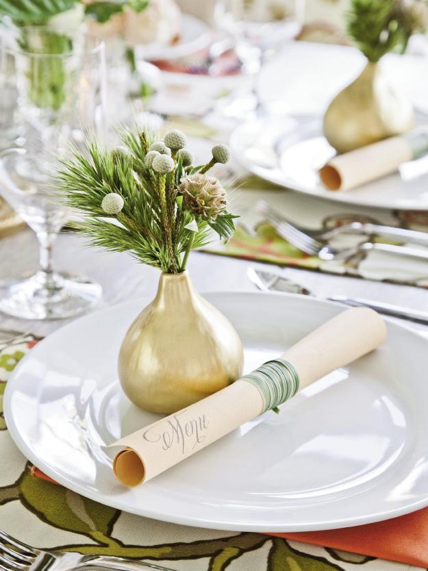 BUDDIES: Menus were printed in-house on peach-toned paper with a calligraphy-style font, then wrapped and tied with long-stemmed grass. Topping place settings with bud vases added pops of color throughout.