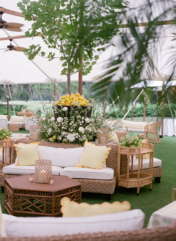 Woven furniture and butter-yellow accent pillows lent the open-air lounge a breezy charm.