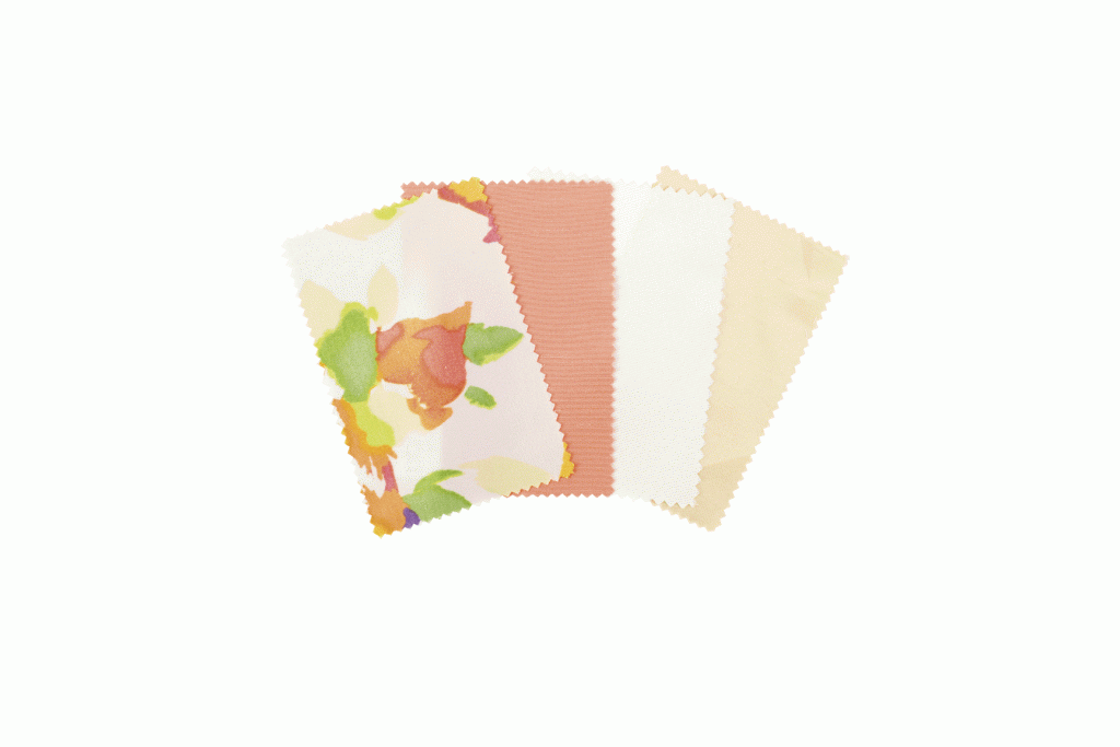 1. FANCY PRETTY FABRICS: Peach, ivory, and gold-hued linens will dress tables, while the floral pattern will cover seat cushions atop gold Chiavari chairs. (Fabric: BBJ Linen)