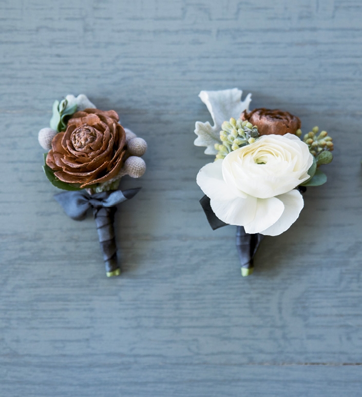 Pinecones offered an earthy twist to otherwise winter-white boutonnieres and bouquets.
