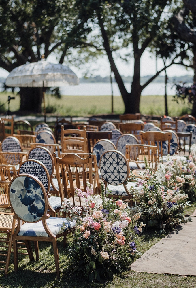 Mismatched chairs from Ooh! Events and French Eclectic, Balinese tasseled umbrellas from Adorn Charleston.