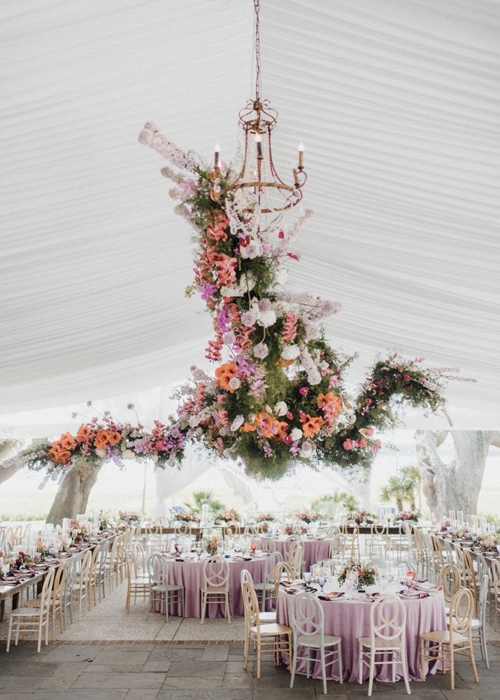 The largest installation sprawled across the reception tent ceiling in a spectacular organic and asymmetrical manner. Incorporated into the tablescapes to add a touch of unexpected whimsy were a variety of brass figurine creatures.