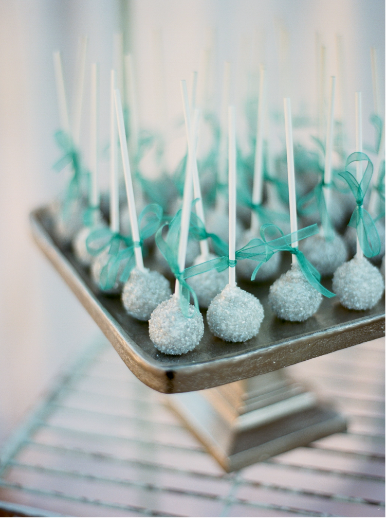 Cake pops dusted in ice blue sugar crystals were part of a dessert spread that included a towering traditional wedding cake.