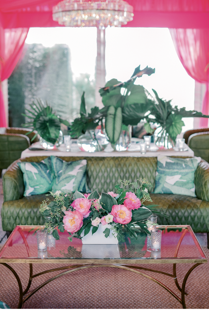 Filling the tent with lounge appointments—leather sofas, crystal chandeliers, gauzy drapery—in vivid hues was a lively departure from the site’s usual “blush and bashful” trappings, said planner Mary Martha.