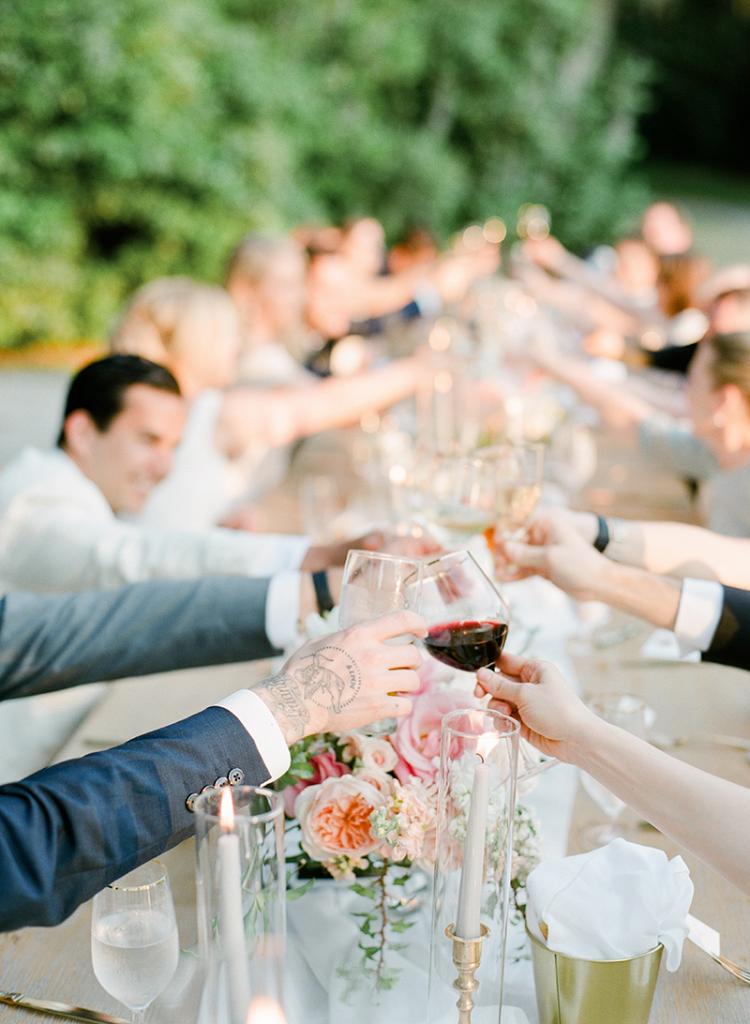 Toast to that! The couple&#039;s smaller guest list allowed everyone to revel in head table pampering, from fine wine to upholstered dining chairs for all.