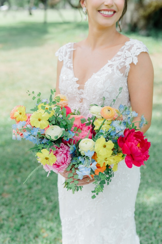 A loosely gathered bouquet of multicolored peonies, ranunculus, roses, delphiniums, and nigella evokes a free-spirited feeling.