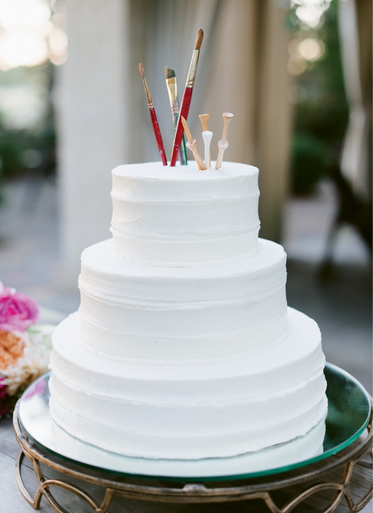 As a nod to the couple’s professions, paintbrushes and golf tees topped the dessert. “We cleaned them thoroughly before sticking them in the cake!” laughs Teil. (Image by Natalie Franke Photography)