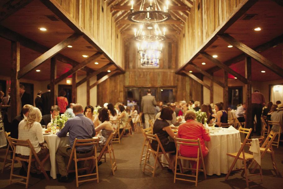 CARRIAGE HOUSE RULES: &quot;I loved the wagon wheel chandeliers,&quot; says Ashton of the carriage house&#039;s rustic décor.