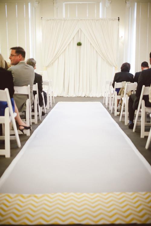 ON THE BORDER: Jacqueline Lawrence of inventivENVIRONMENTS spiced up a traditional white aisle runner by sewing on a yellow chevron printed trim.