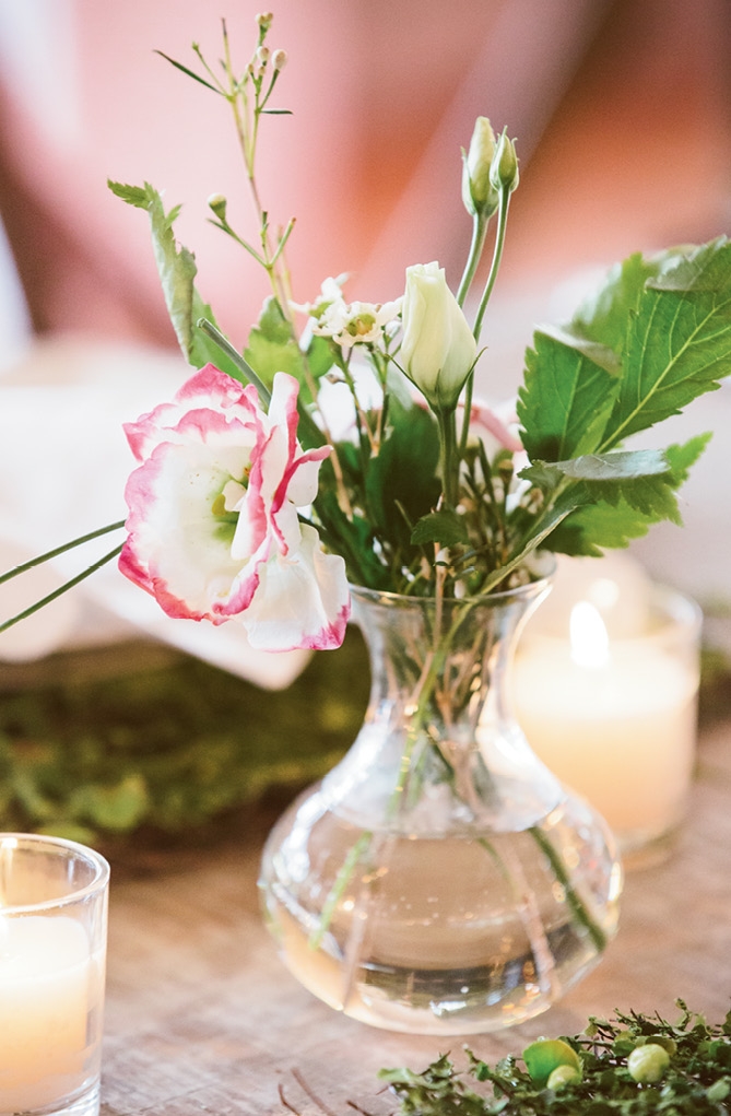Diminutive vases decorated tabletops so as not to compete with the flower feature wall and hanging arrangements.  &lt;i&gt;Amelia + Dan Photography&lt;/i&gt;