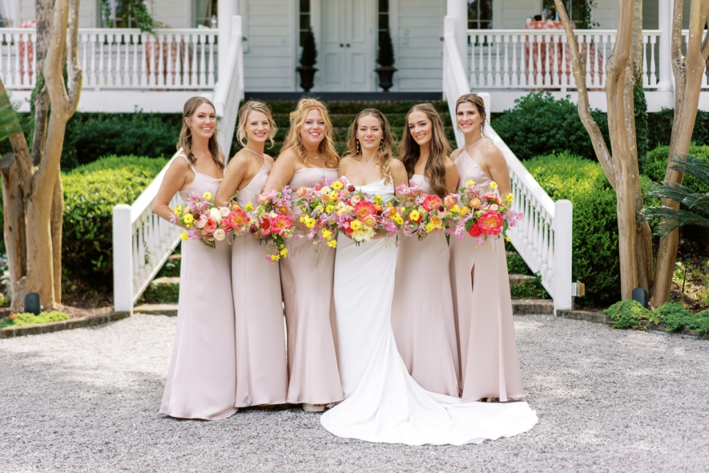 Bridesmaids donned satin Jenny Yoo dresses in “Prosecco.”