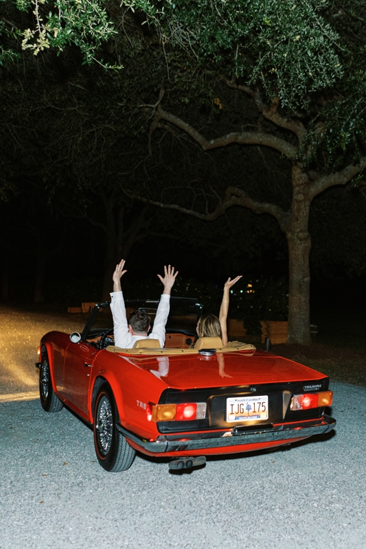 The couple’s getaway car was a nod to the groom’s parents, who met thanks to a shared affinity for his father’s red Triumph TR6.