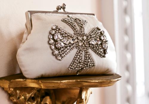 Ivory satin clutch with rhinestone cross from Out of Hand ($235)